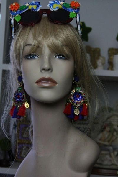 A mannequin wearing colorful earrings and a wig.