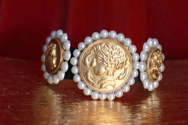 A close up of a belt with pearls and gold coins