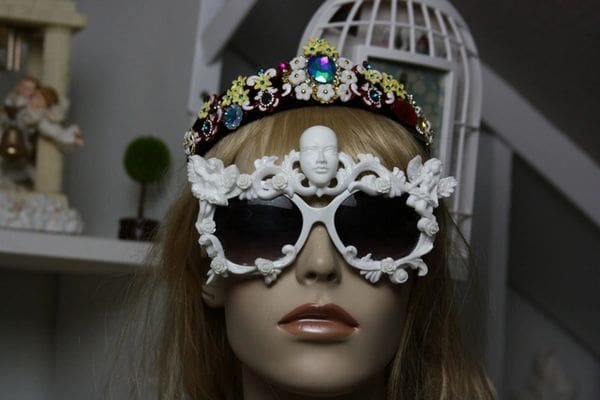 A mannequin wearing sunglasses and a tiara.