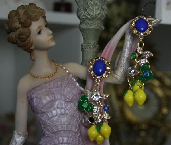 A statue of a woman wearing jewelry and earrings.