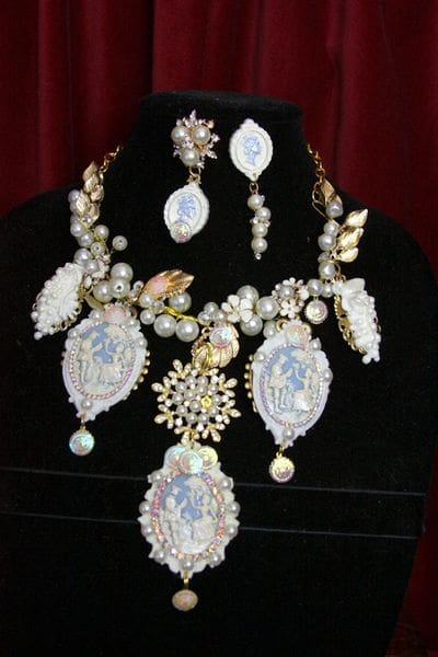 A necklace and earrings set with pearls on display.