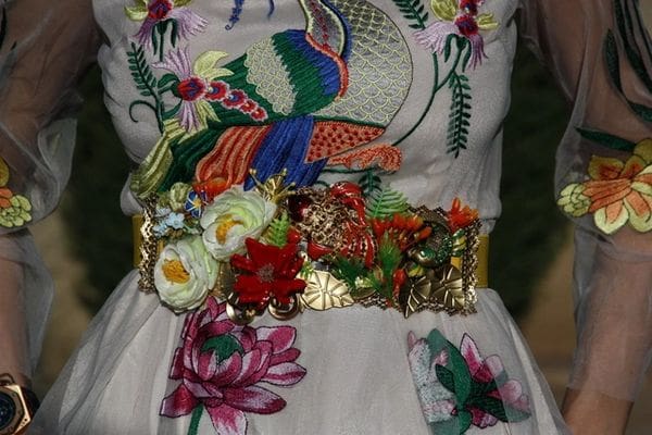 A close up of the waist of a woman wearing a dress