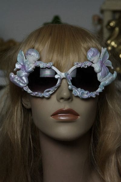 A mannequin wearing sunglasses with flowers on them.