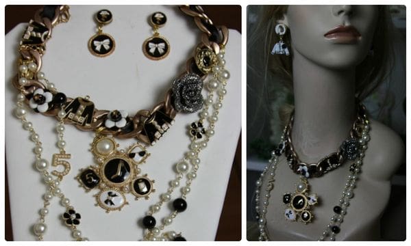 A necklace and earrings set with black, white and gold beads.