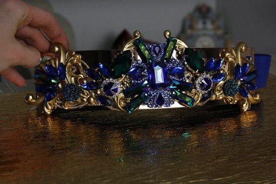 A woman is holding onto the crown of her head