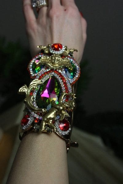 A woman 's arm with a colorful bracelet on it.