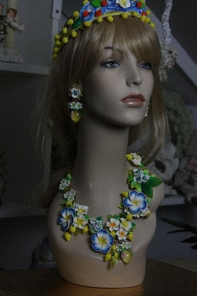 A mannequin wearing a necklace and earrings.