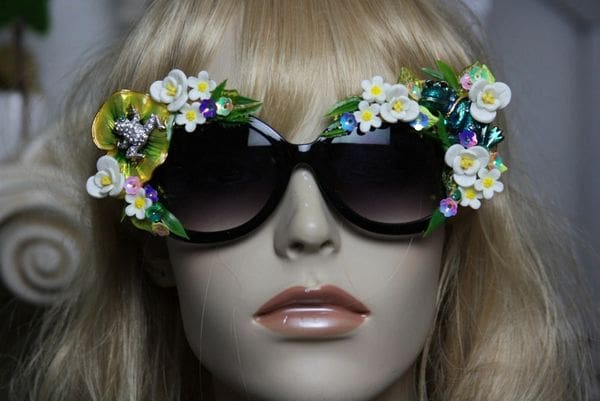 A mannequin wearing sunglasses with flowers on them.