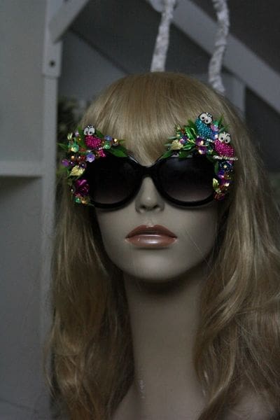 A mannequin wearing sunglasses with flowers on them.