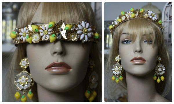 A mannequin wearing a headpiece and earrings.