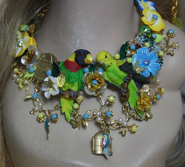 A necklace with many different colored flowers and birds.
