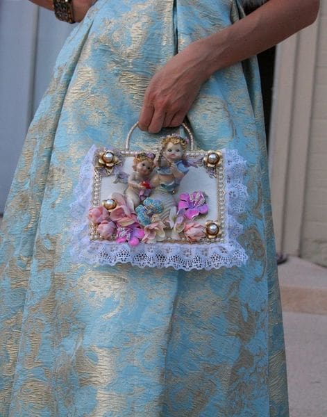 A woman holding onto a purse with flowers
