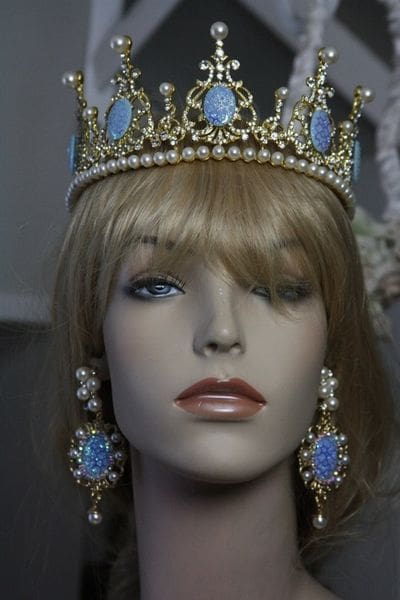 A mannequin wearing a crown and earrings.
