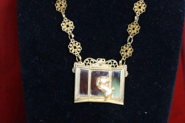 SOLD! 7742 Baroque Gold Tone Metal Puppy In A Mirror Necklace