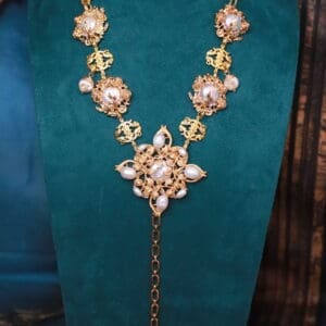 A necklace with pearls and gold on it