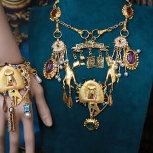 A woman 's hand and jewelry on display.