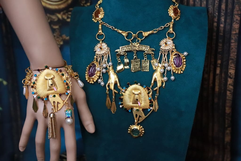 A woman 's hand and jewelry on display.