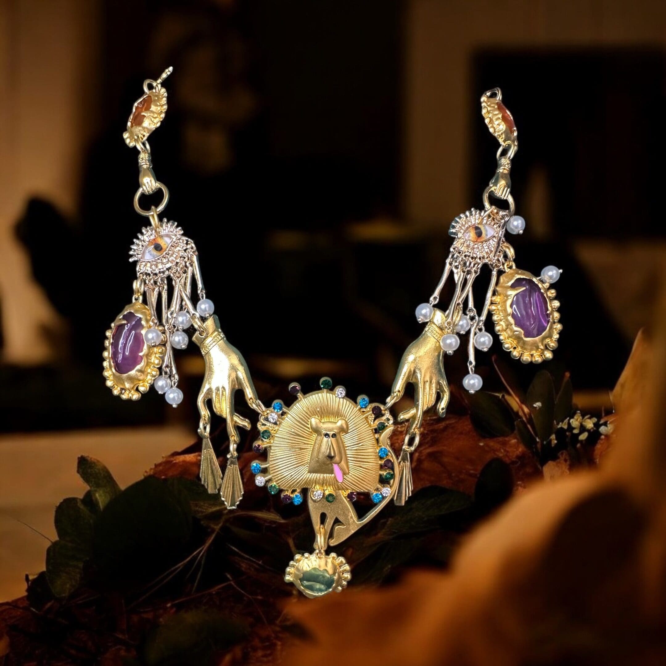 A necklace with a crown and earrings on it.