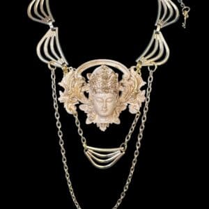 A necklace with chains and a face on it.