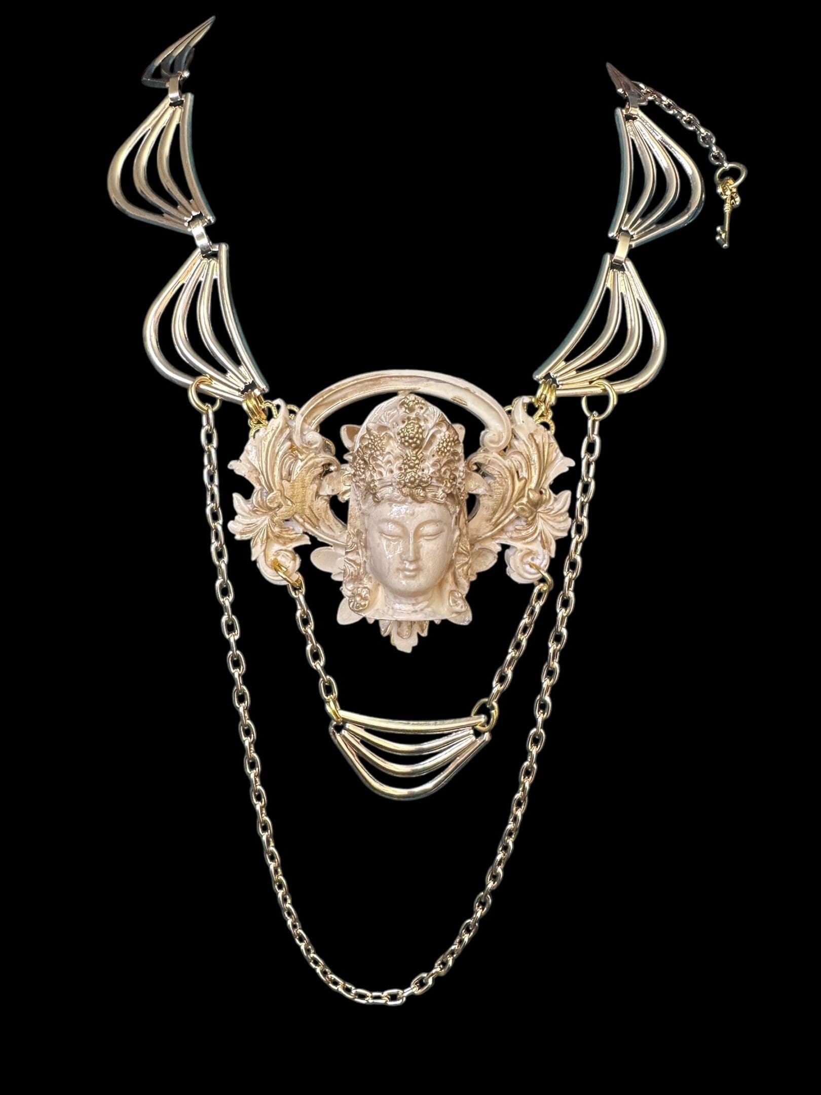 A necklace with chains and a face on it.