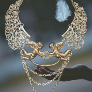 A necklace with two angels on it and feathers