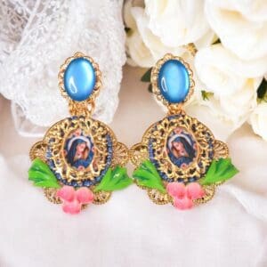 A pair of earrings with blue and pink flowers.