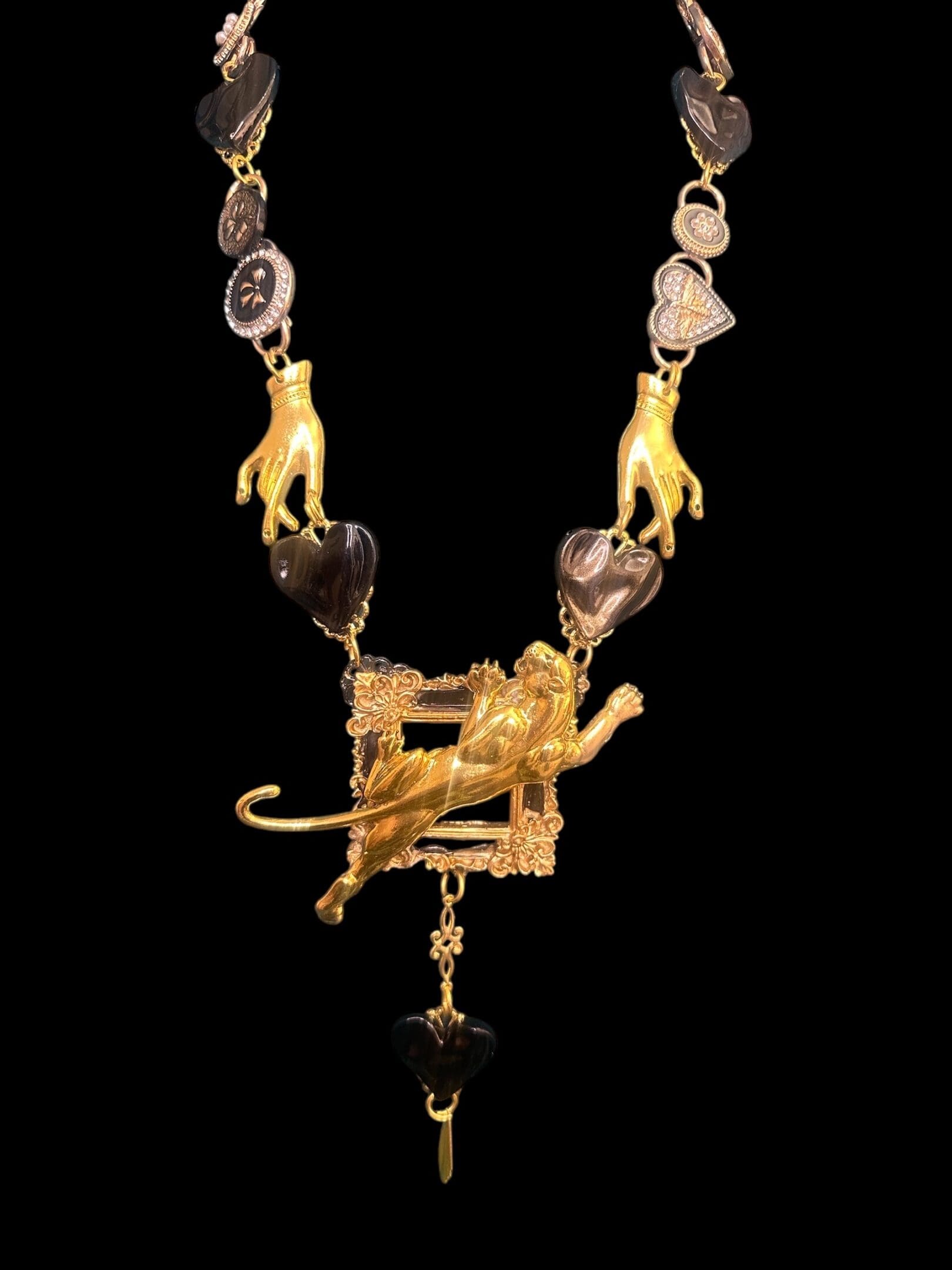 A necklace with gold lion and other animal designs.