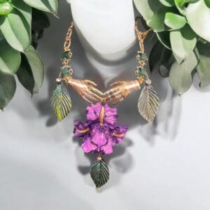 A necklace with purple flowers and leaves on it.