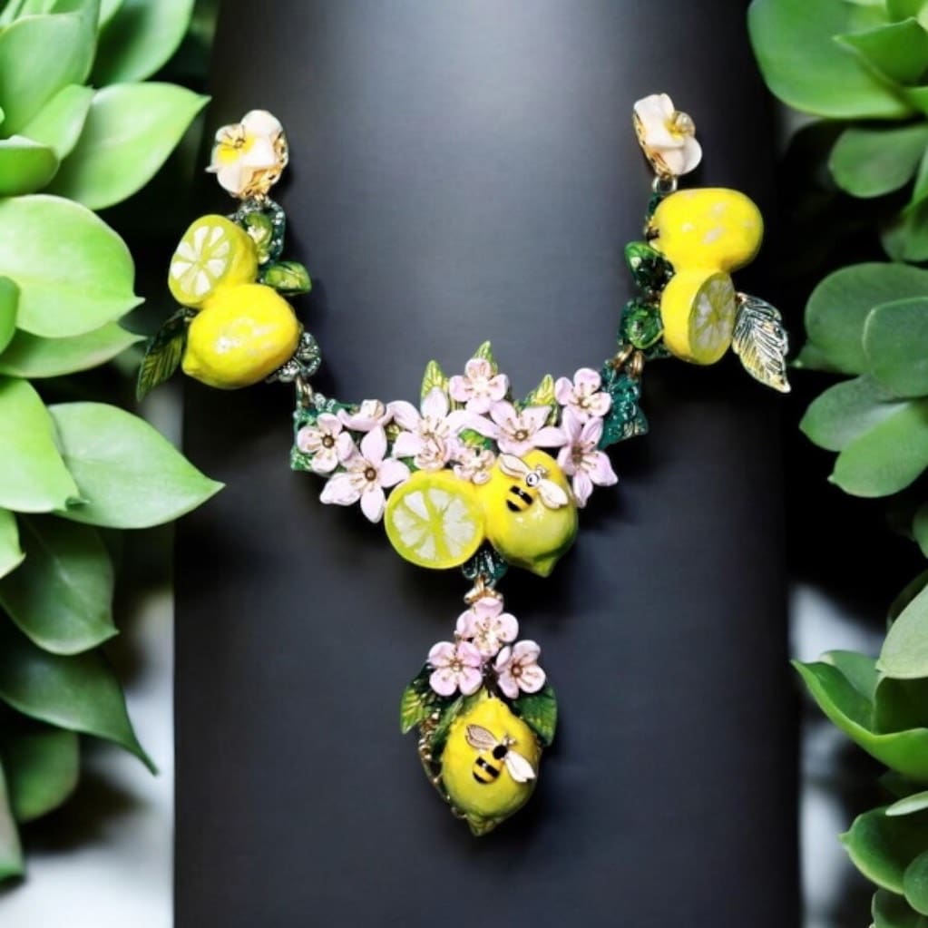 A necklace with lemons and flowers on it