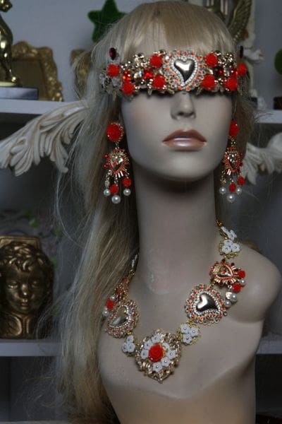 A woman wearing jewelry and a head piece.