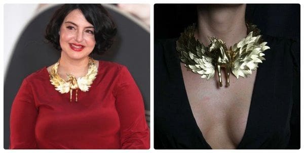 A woman wearing a red dress and gold necklace.