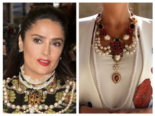 A woman wearing two different necklaces and one is wearing a necklace