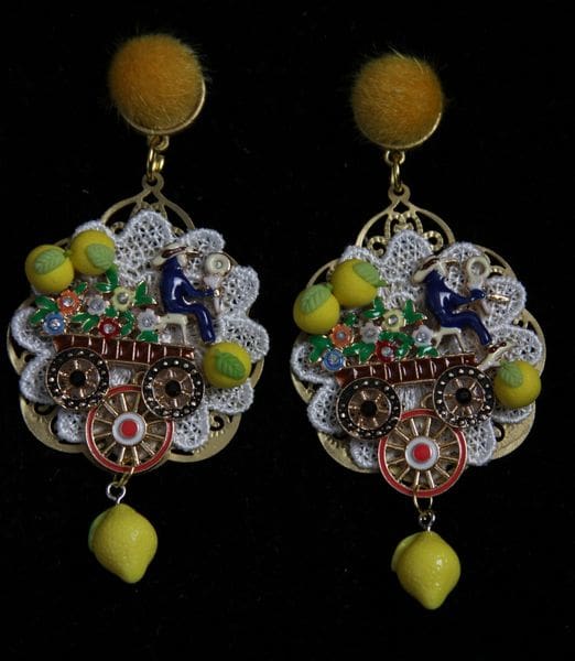 A pair of earrings with lemons and other fruits.