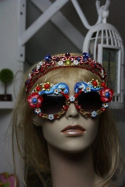 A mannequin wearing sunglasses and a head piece.