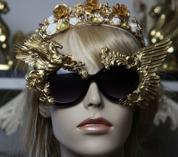 A mannequin wearing sunglasses and a crown.