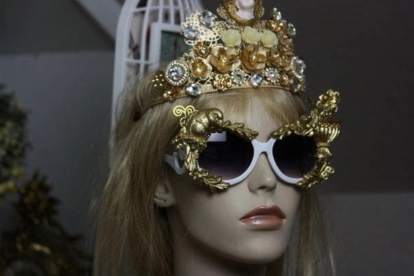 A mannequin wearing sunglasses and a crown.