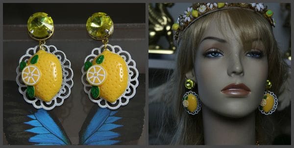 A woman wearing a yellow lemon earring and a green stone tiara.