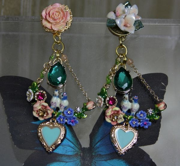 A pair of blue shoes with flowers and pearls.