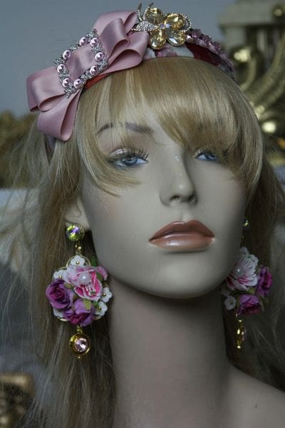 A mannequin with pink accessories and long blonde hair.