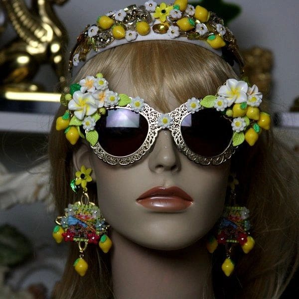 A mannequin wearing sunglasses and headpieces.