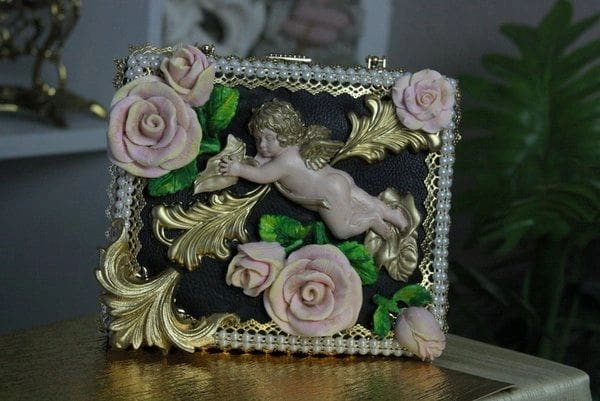 A picture of a decorative box with a cherub and roses.