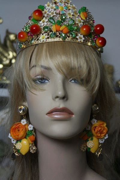 A mannequin wearing a crown and earrings.