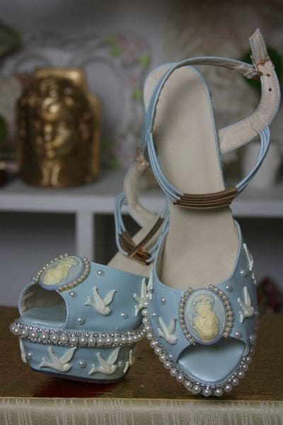 A pair of blue shoes with white and yellow designs.